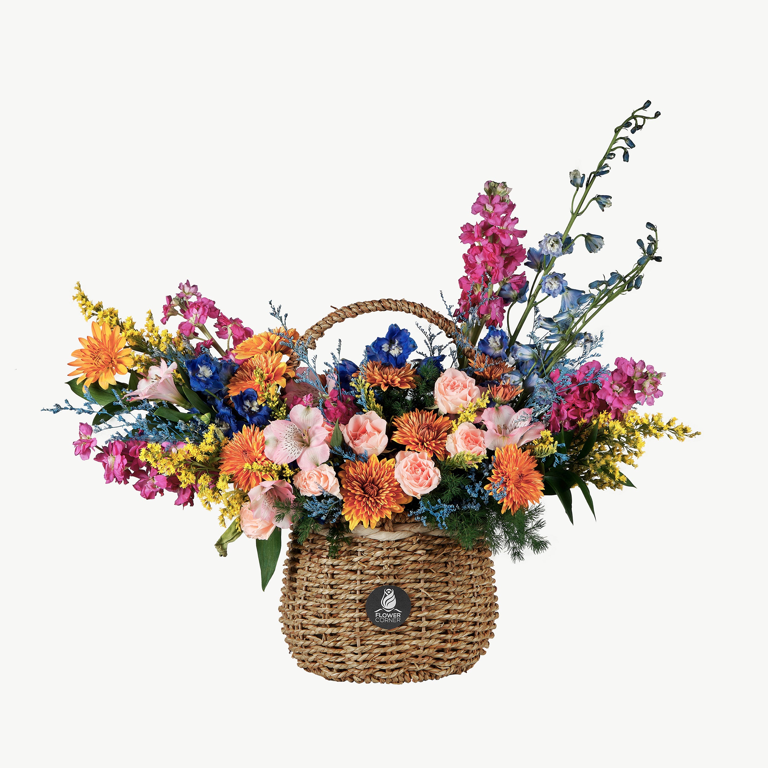Colorful flower arrangement in a woven basket on a white background
