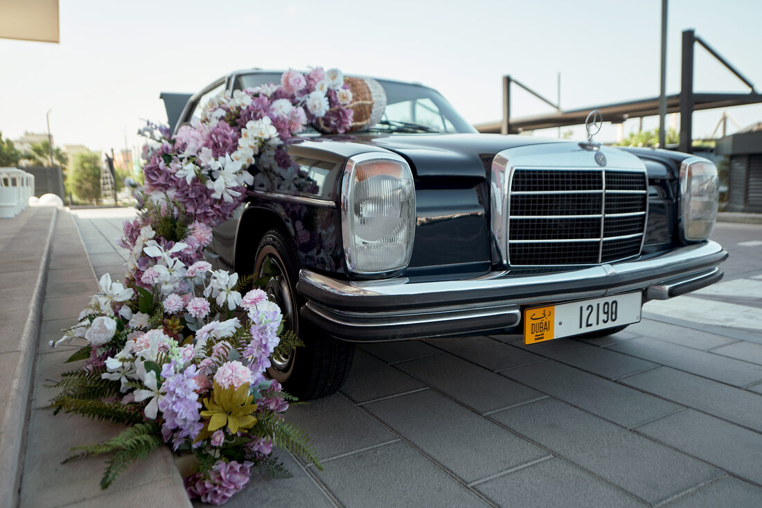 Flower Corner's classic wedding car dressed with fresh flowers