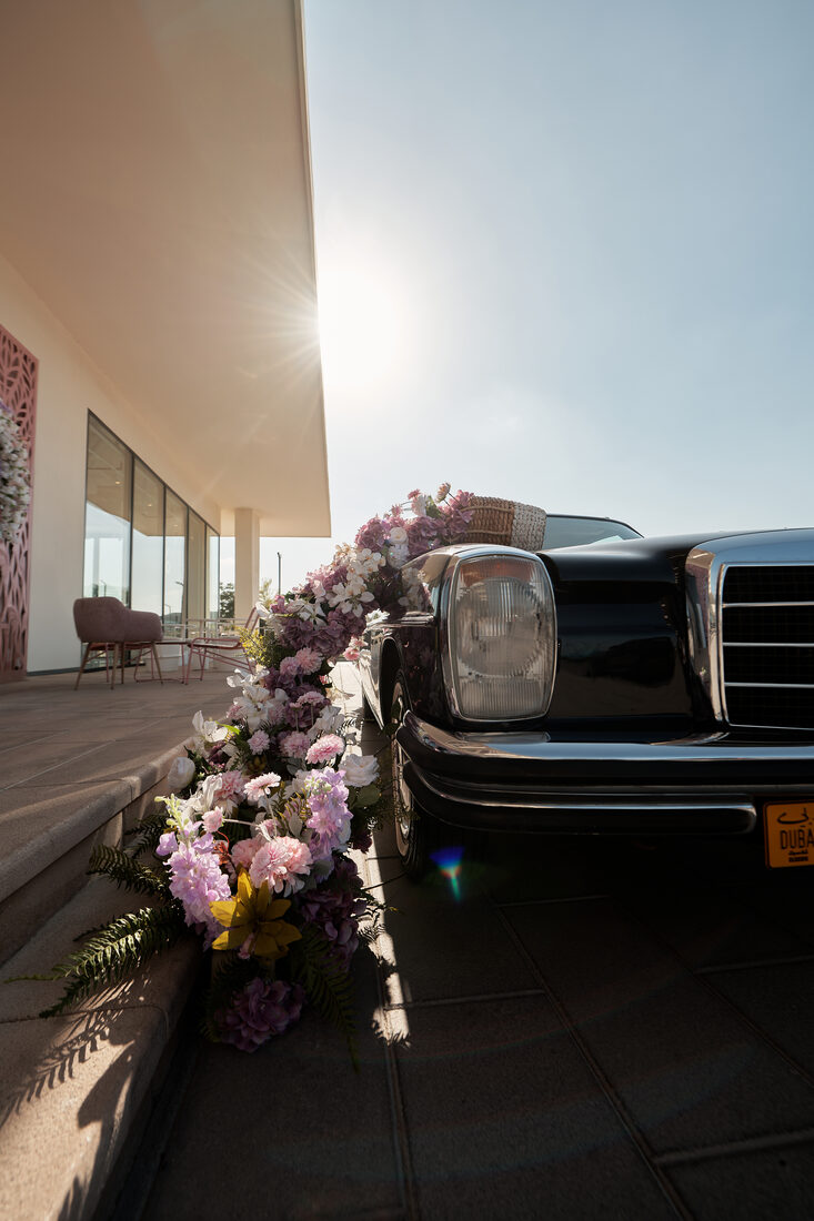 Flower Corner's classic wedding car dressed with fresh flowers